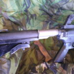 Buy Colt Commando clone XM177-style 5.56 rifle online featuring retro Vietnam-inspired tactical styling, Spikes Havoc launcher, battleworn Cerakote finish, and premium custom rifle upgrades.