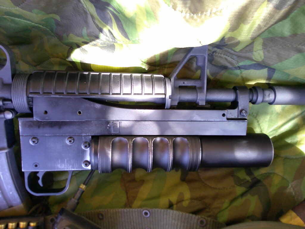 Buy Colt Commando clone XM177-style 5.56 rifle online featuring retro Vietnam-inspired tactical styling, Spikes Havoc launcher, battleworn Cerakote finish, and premium custom rifle upgrades.