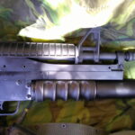 Buy Colt Commando clone XM177-style 5.56 rifle online featuring retro Vietnam-inspired tactical styling, Spikes Havoc launcher, battleworn Cerakote finish, and premium custom rifle upgrades.
