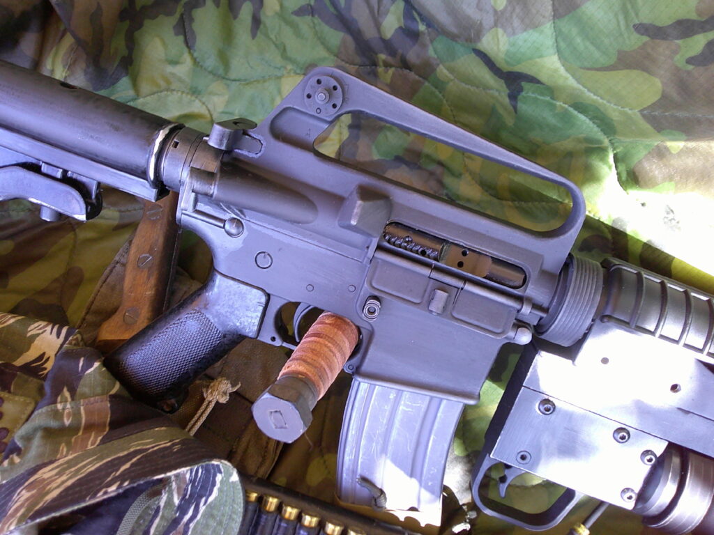 Buy Colt Commando clone XM177-style 5.56 rifle online featuring retro Vietnam-inspired tactical styling, Spikes Havoc launcher, battleworn Cerakote finish, and premium custom rifle upgrades.