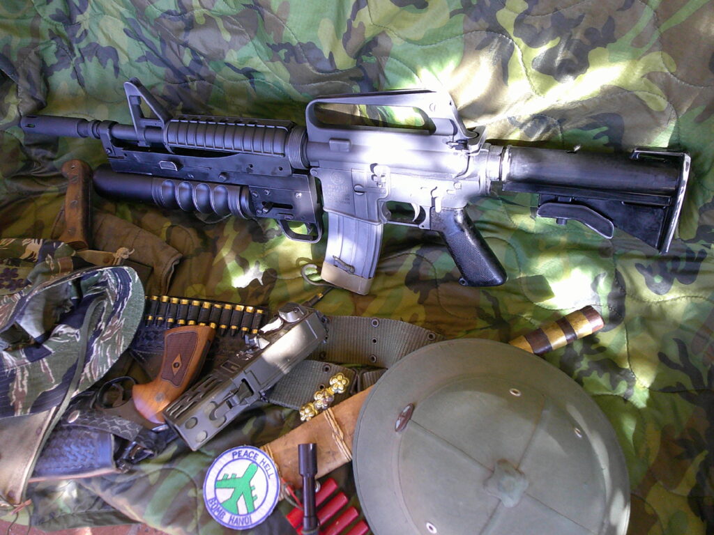 Buy Colt Commando clone XM177-style 5.56 rifle online featuring retro Vietnam-inspired tactical styling, Spikes Havoc launcher, battleworn Cerakote finish, and premium custom rifle upgrades.