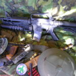 Buy Colt Commando clone XM177-style 5.56 rifle online featuring retro Vietnam-inspired tactical styling, Spikes Havoc launcher, battleworn Cerakote finish, and premium custom rifle upgrades.