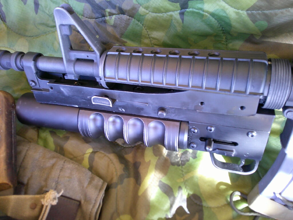 Buy Colt Commando clone XM177-style 5.56 rifle online featuring retro Vietnam-inspired tactical styling, Spikes Havoc launcher, battleworn Cerakote finish, and premium custom rifle upgrades.
