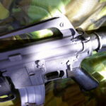 Buy Colt Commando clone XM177-style 5.56 rifle online featuring retro Vietnam-inspired tactical styling, Spikes Havoc launcher, battleworn Cerakote finish, and premium custom rifle upgrades.