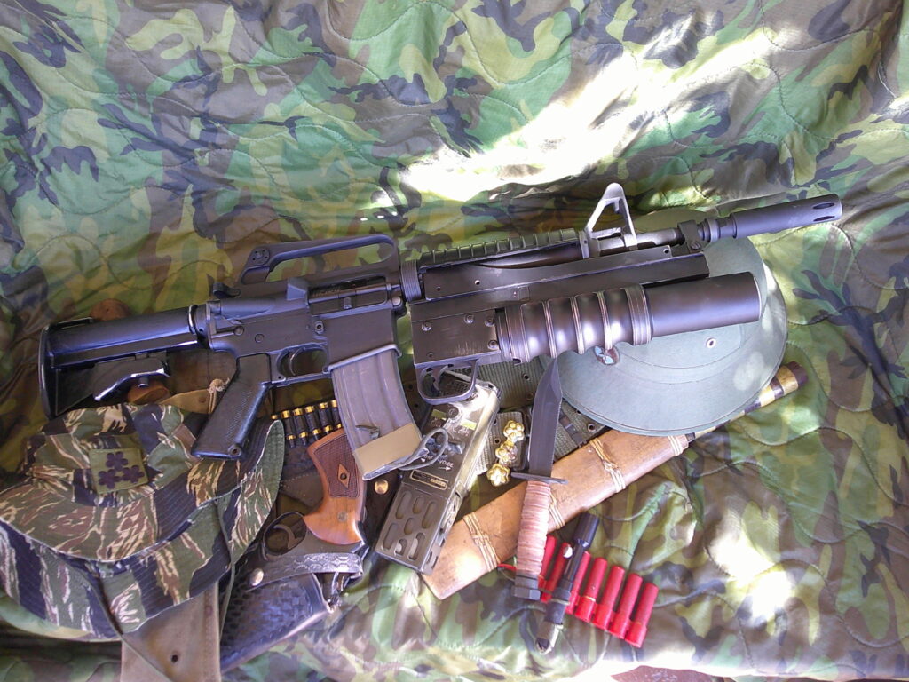 Buy Colt Commando clone XM177-style 5.56 rifle online featuring retro Vietnam-inspired tactical styling, Spikes Havoc launcher, battleworn Cerakote finish, and premium custom rifle upgrades.