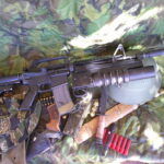Buy Colt Commando clone XM177-style 5.56 rifle online featuring retro Vietnam-inspired tactical styling, Spikes Havoc launcher, battleworn Cerakote finish, and premium custom rifle upgrades.